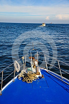 Bow of a ship sailing on a bright blue day