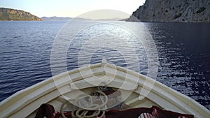 Bow of a White Wooden Boat Sailing On Sea
