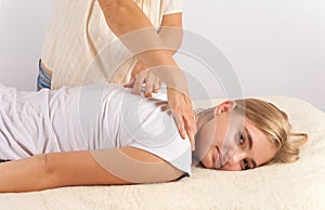 Bowen masage therapy of a young woman photo