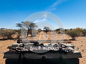 Bowhunting equipment on top of a truck traveling down a dirt road in Africa