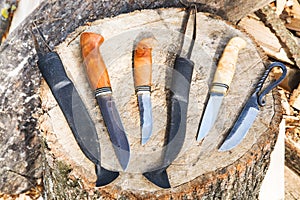 Bowie knives on wooden stump