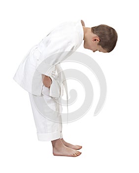 Bowing boy in judo kimono,