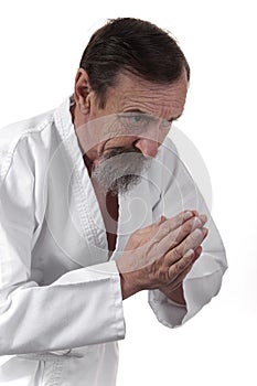 Bowing senior karate practicing man