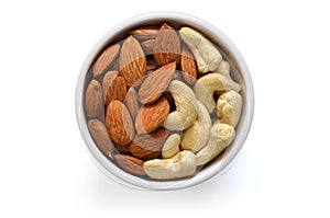 Bowl with almond and cashew - top view with isolated in white ba