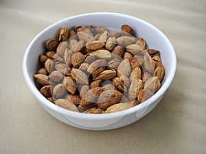 Bowl of almonds on canvas