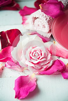 Bowl of aroma spa water with rose petals on towel, closeup