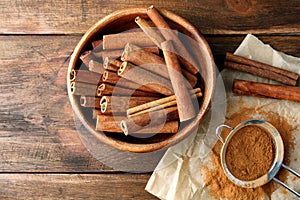 Bowl with aromatic cinnamon sticks and powder