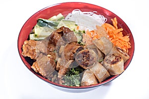 Bowl of beef Bo bun with salad, pork ribs, fresh herbs