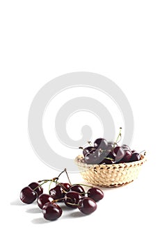 A bowl of black cherry isolated on white background