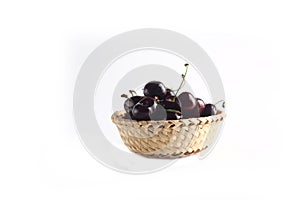 A bowl of black cherry isolated on white background