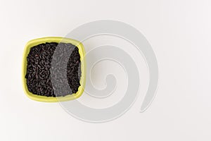 Bowl of black wild rice isolated on white background