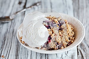 Bowl of Blackberry Blueberry Cobbler with Ice Cream Scoops photo