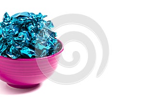 A Bowl of Blue Wrapped Candy on a White Background