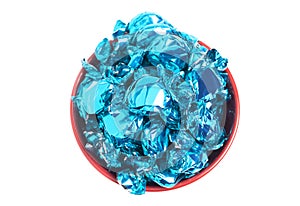 A Bowl of Blue Wrapped Candy on a White Background