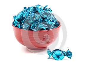 A Bowl of Blue Wrapped Candy on a White Background