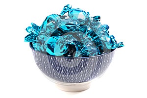 A Bowl of Blue Wrapped Candy on a White Background