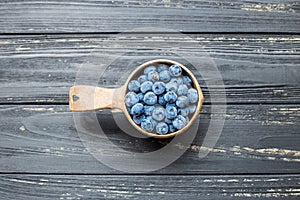 Bowl with blueberries on center of black table