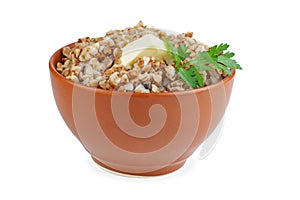 Bowl of boiled buckwheat grains with green branch of parsley