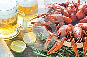 Bowl of boiled crayfish with two mugs of beer