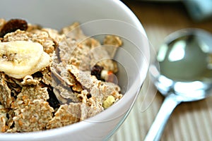 A bowl of bran flakes with raisins