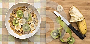 Bowl of Breakfast Cereal with Banana and Kiwi Fruit