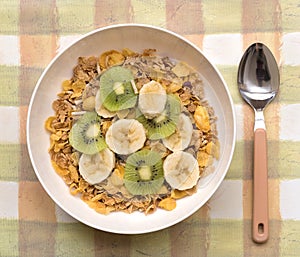 Bowl of Breakfast Cereal with Banana and Kiwi Fruit