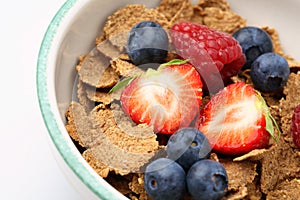 Bowl of breakfast cereal with fruit.