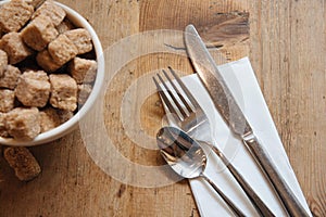 Bowl with brown sugar and silverwear