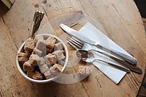 Bowl with brown sugar and silverwear