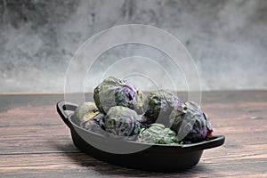 A Bowl of Brussels Sprouts on grey background