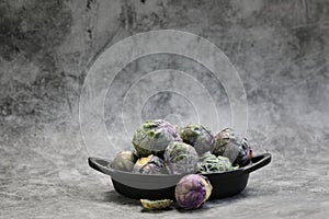 A Bowl of Brussels Sprouts on grey background