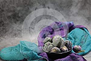 A Bowl of Brussels Sprouts on grey background