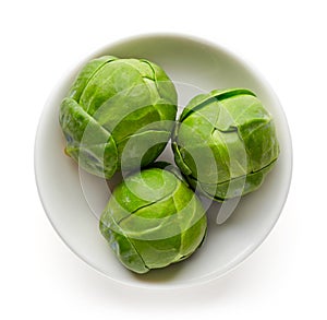 Bowl of Brussels sprouts isolated on white from above