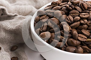 Bowl of coffee beans on a white background