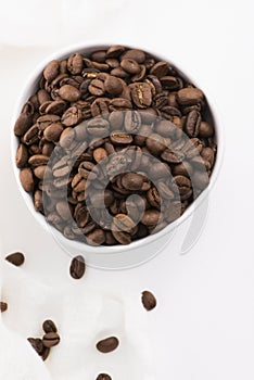 Bowl of coffee beans on a white background