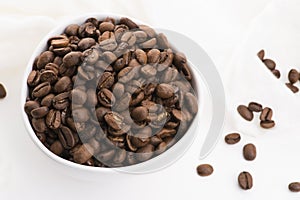 Bowl of caffee beans on a white background