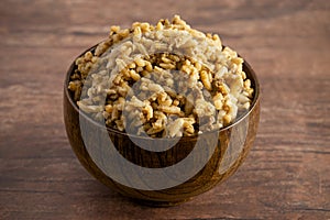 Bowl of Cajun Dirty Rice on a Rustic Wooden Table