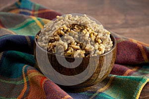 Bowl of Cajun Dirty Rice on a Rustic Wooden Table