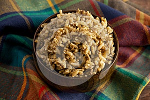 Bowl of Cajun Dirty Rice on a Rustic Wooden Table