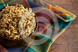 Bowl of Cajun Dirty Rice on a Rustic Wooden Table