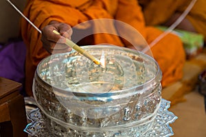 Bowl with a candle and holy water