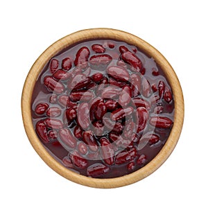 Bowl of canned red kidney beans on white background, top view