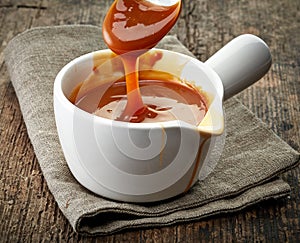 Bowl of caramel sauce photo