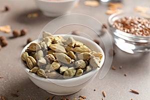 Bowl with cardamon on table, closeup