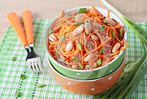 Bowl of carrot salad with beans and green onions