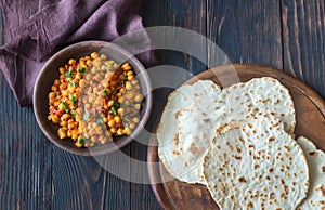 Bowl of chana masala with flatbread