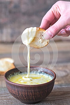 Bowl of cheese dip with toasts photo