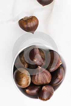 Bowl of chestnuts on a white background