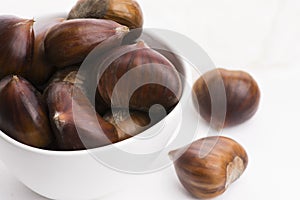 Bowl of chestnuts on a white background