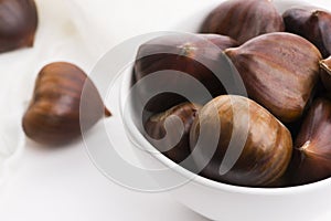 Bowl of chestnuts on a white background